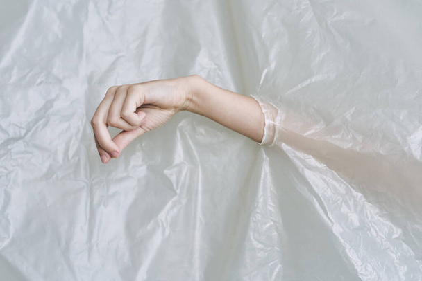 female hand   tearing plastic, polyethylene - 写真・画像