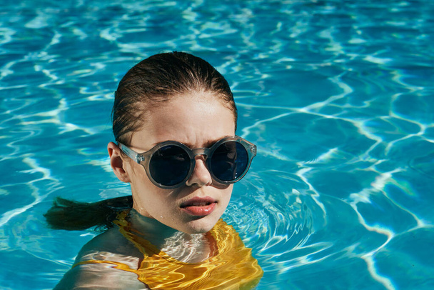 Young beautiful woman relaxing in the pool   - Fotoğraf, Görsel
