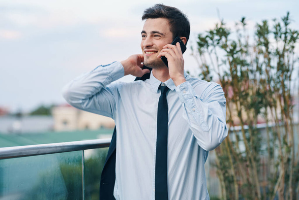 young handsome businessman talking on smartphone - Фото, изображение