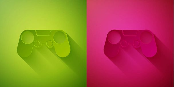 Řez papíru ikona Gamepad izolované na zeleném a růžovém pozadí. Herní ovladač. Papírový styl. Vektorová ilustrace - Vektor, obrázek