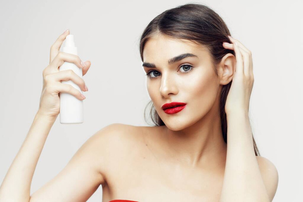 Young beautiful woman with beauty product  in studio  - 写真・画像