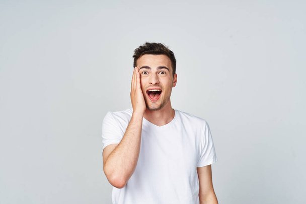 Young   happy surprised  man   in studio,  isolated  background - Foto, Imagen
