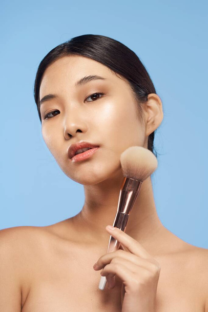 Young asian woman with powder brush  - Foto, Imagen