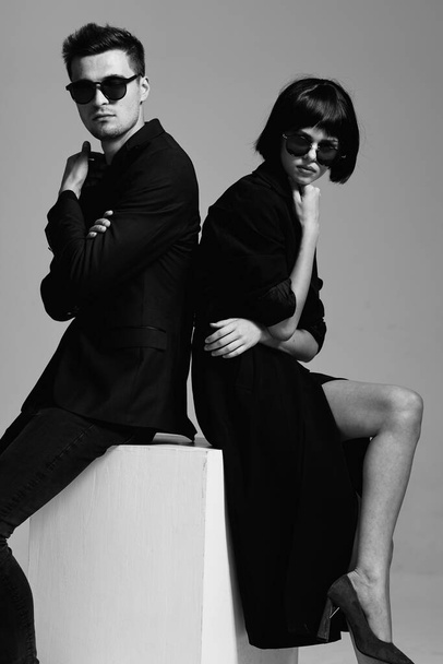 Young beautiful couple posing in studio. Black and white - Fotografie, Obrázek