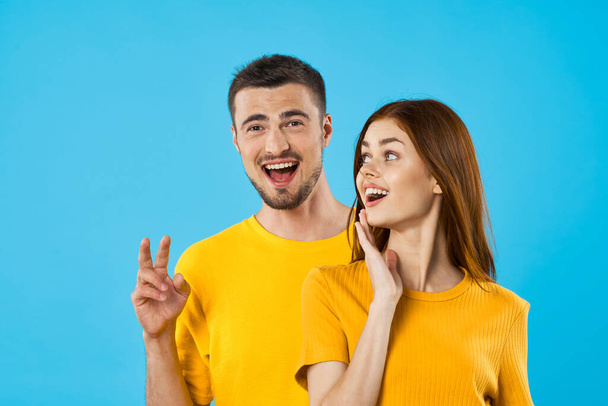 young  handsome man and woman in studio  on blue background  - Photo, Image