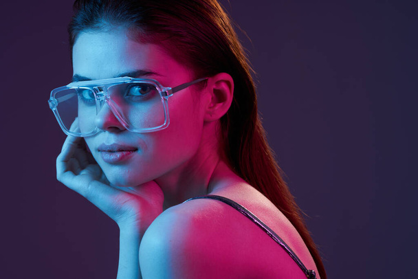 young beautiful fashion woman in glasses posing in studio - Фото, изображение
