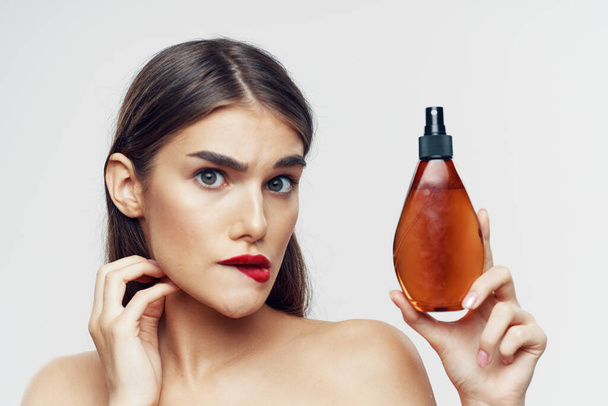 Young beautiful woman with beauty product  in studio  - Fotografie, Obrázek