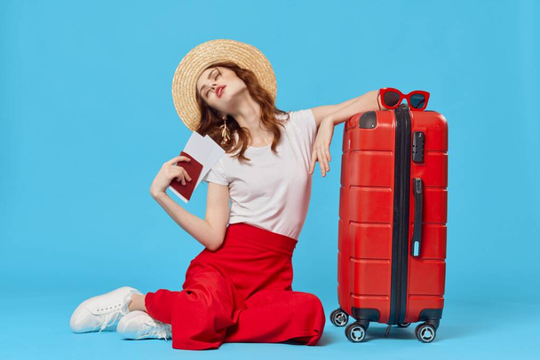Young woman with red suitcase in studio - Foto, Imagem