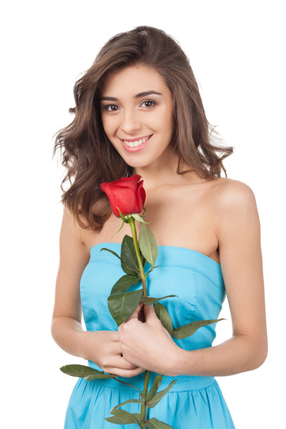 Beautiful young woman holding a red rose - Fotografie, Obrázek