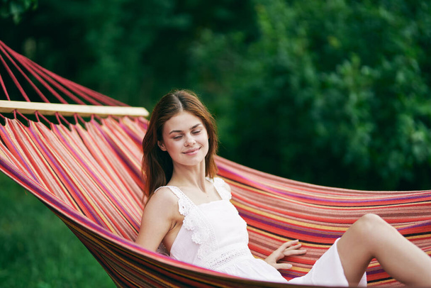 Young beautiful woman relaxing in hammock - Φωτογραφία, εικόνα