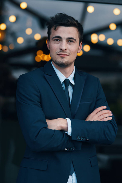 young handsome businessman on the street with arms crosses - Foto, Bild