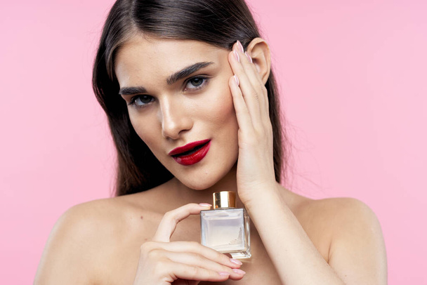 young beautiful woman with beauty product bottle   in studio - Photo, Image