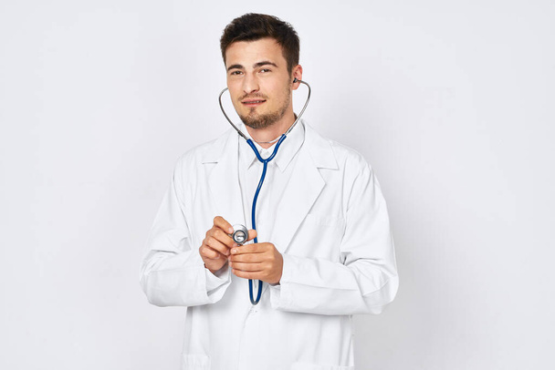 Studio shot. Young doctor  with stethoscope on  isolated background  - Foto, immagini