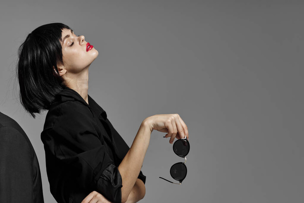  beautiful woman posing with  sunglasses  in studio - Fotó, kép