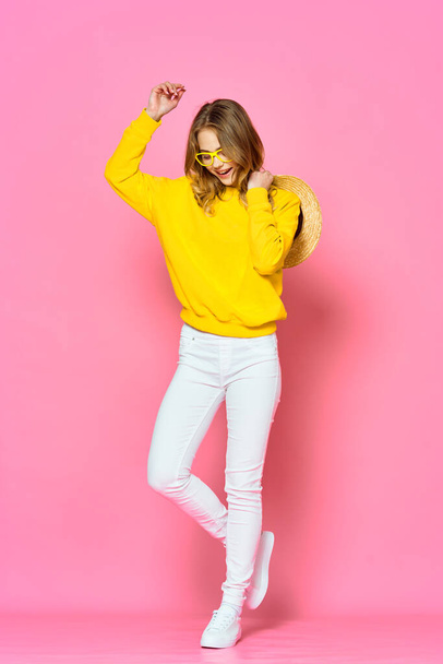 young beautiful woman  dancing   in studio on pink background       - Foto, afbeelding