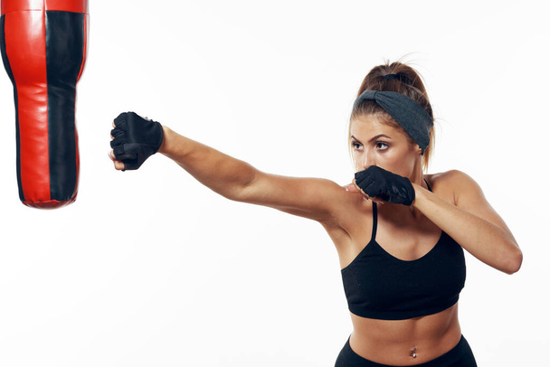 Studio shot. Young fit woman boxer exercising, isolated background - Photo, Image