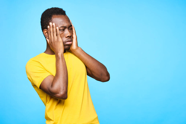 Young african man has problem    isolated on blue background - Fotó, kép