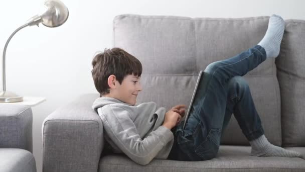 A boy playing with a tablet celebrating victory - Footage, Video