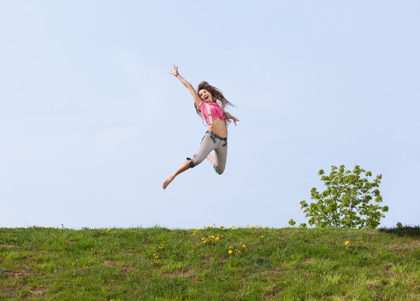 Happy young woman jumping - 写真・画像