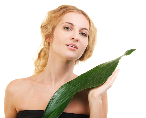 Portrait of the beauty young blond woman with green leaf - Photo, Image