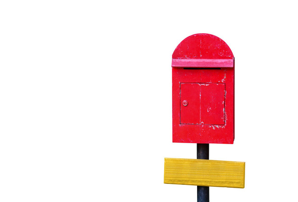 clipping path, old red wooden mailbox on black pillar with blank yellow wooden sign isolated on white background, copy space - Photo, Image