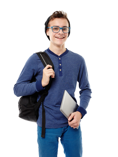 Cheerful teenager with backpack wearing cap and glasses and hold - Valokuva, kuva