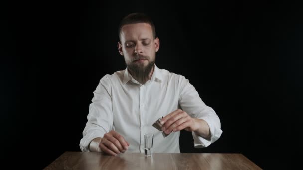 The bartender pours sambuca from jigger to cocktail glass - Materiał filmowy, wideo