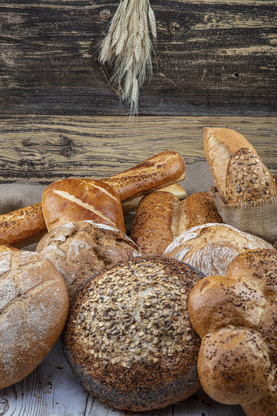 Fresh fragrant bread on the table. Food concept  - Фото, зображення