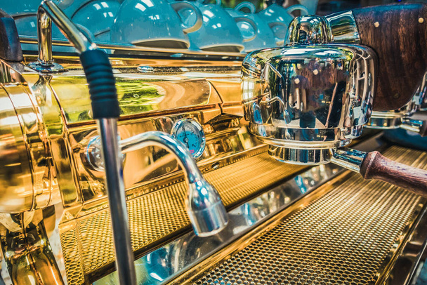 Golden coffee maker in an expensive restaurant - Fotó, kép