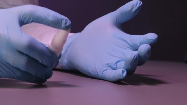Hands with medical gloves treated with an antiseptic. - Metraje, vídeo