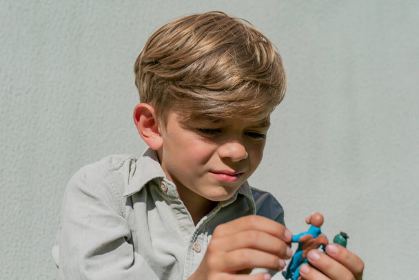 A little boy plays and shows his plasticine crafts - Foto, Imagem