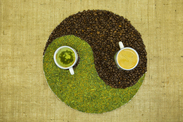The concept of yin yang. Sign yin yang against the background of burlap. Japanese match tea with fried rice and Cuban coffee were used. - Photo, Image