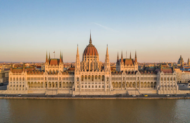 Aerial drone shot of Hungarian Parliament facade during Budapest sunset hour in winter - Photo, Image
