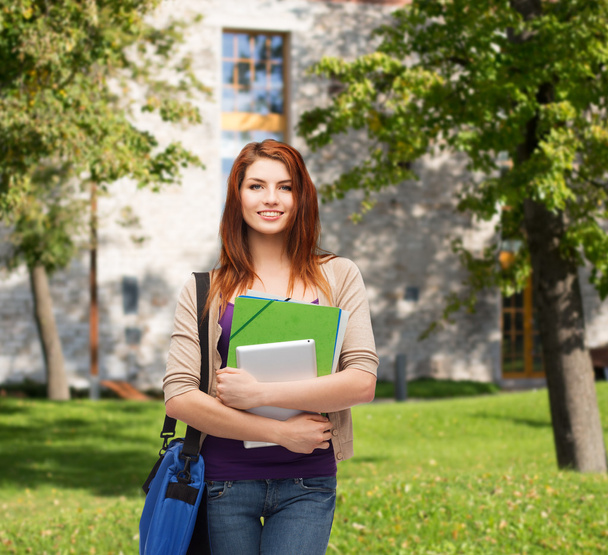 Smiling student with bag, folders and tablet pc - Foto, afbeelding