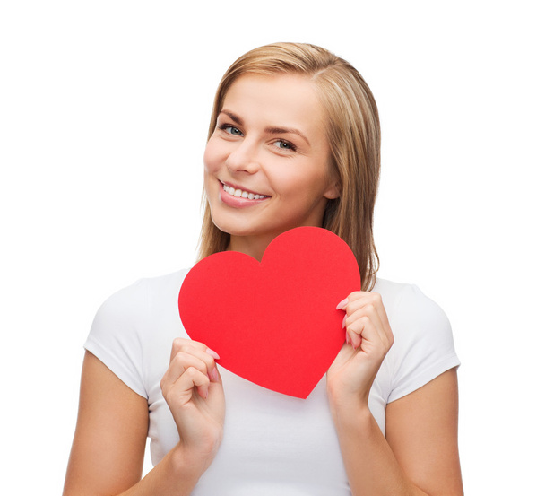 Smiling woman in white t-shirt with heart - Zdjęcie, obraz