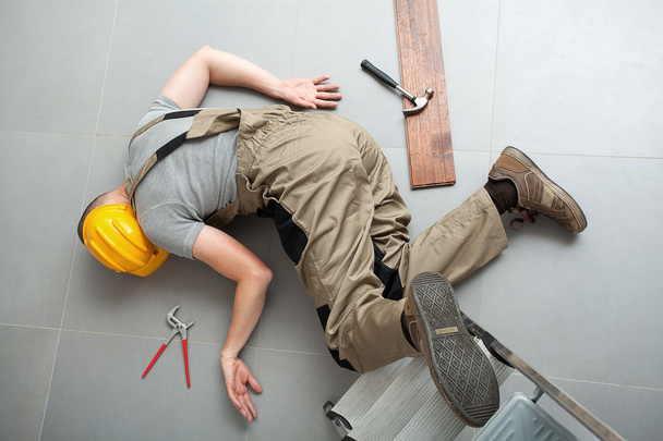 Handyman fell from ladder - Фото, изображение