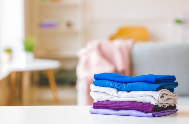 Stack of clean clothes on table in room - Photo, Image