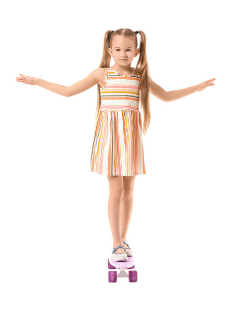 Cute little girl with skateboard on white background - Φωτογραφία, εικόνα