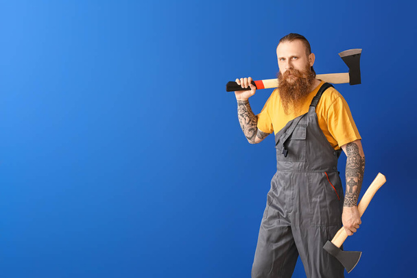 Handsome lumberjack on color background - Photo, Image