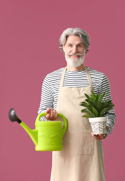 Senior gardener on color background - Photo, Image