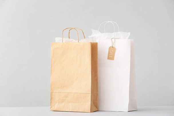 Paper shopping bags on light background - Photo, image