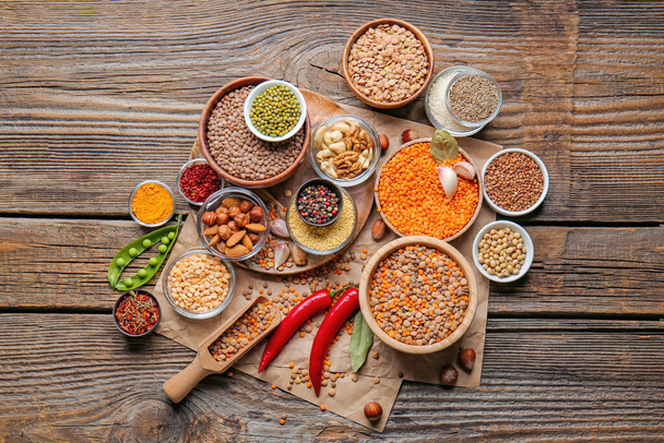 Different raw legumes with spices on table - Foto, Imagem