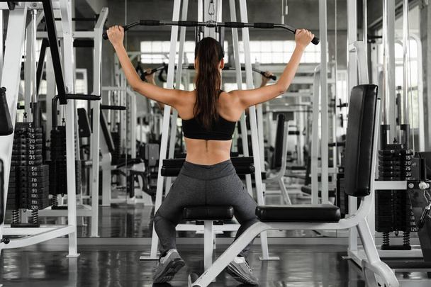 caucasian ethletics woman in sportswear workout and exercise with weightlifting in gym and fitness club - Foto, Imagem
