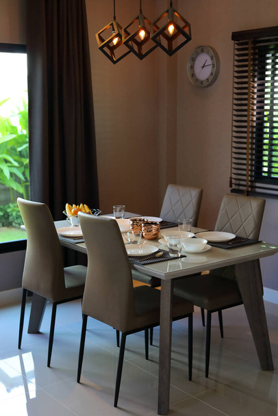 dish ware sets arrange on dining table inside eating room of modern home interior - Фото, изображение