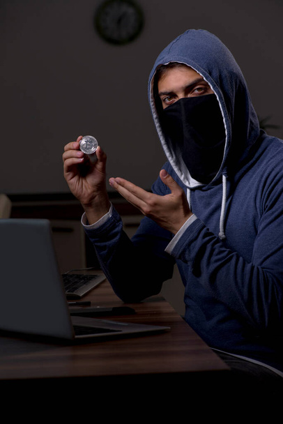 Male hacker hacking security firewall late in office - Foto, Imagem