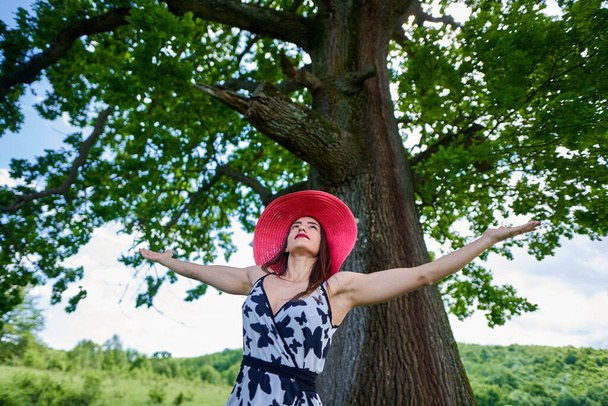 Gorgeous beauty model in summer dress posing outdoor in an oak forest - Zdjęcie, obraz