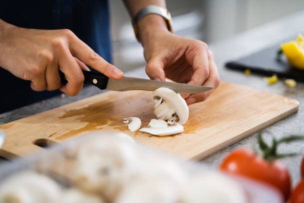 Woman Cooking Dinner At Home Cutting Mushrooms - Valokuva, kuva