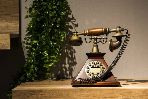 A classical vintage telephone on a wooden table - Fotó, kép