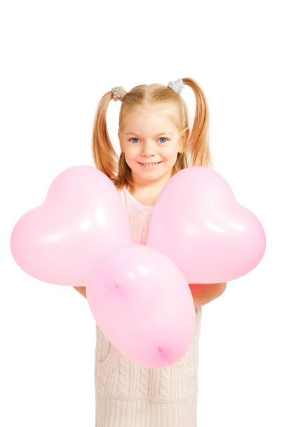 Little kid with balloons in the shape of heart. - Фото, изображение