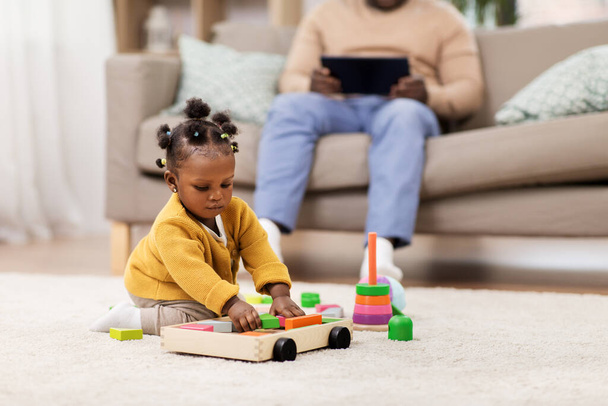 african baby girl playing with toy blocks at home - Foto, imagen